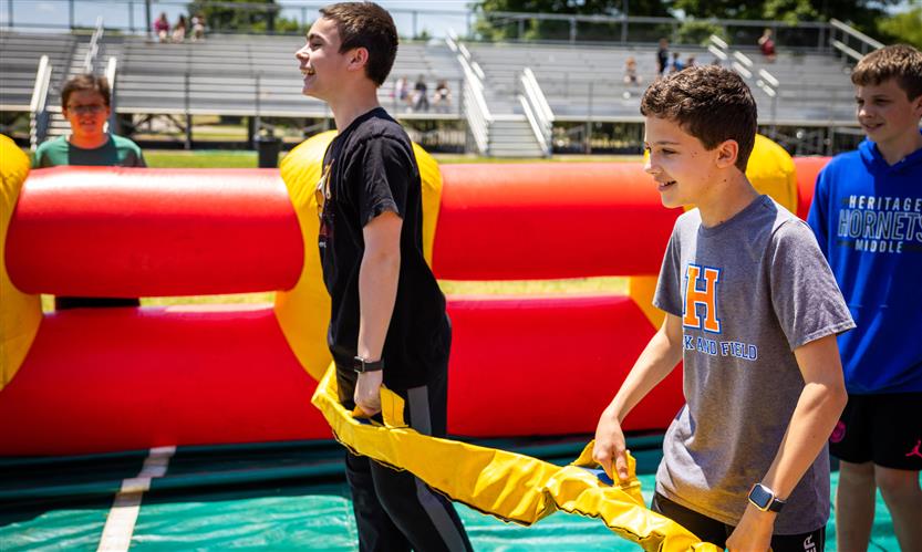Two boys prepare to play life-size foosball